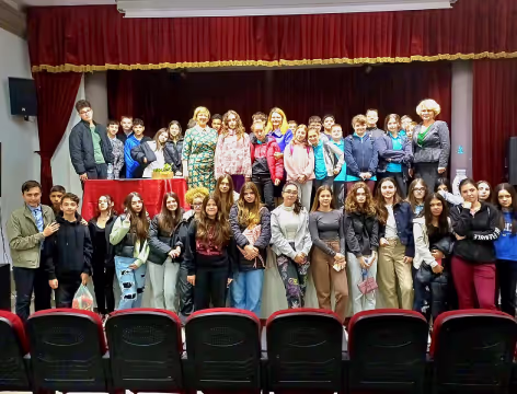 Here is a group of people on a stage from one's of Alina's conferences regarding teenagers